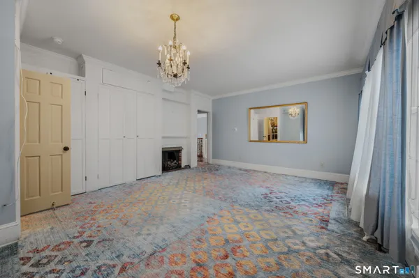 a living room with furniture and a chandelier