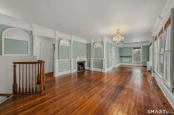 a view of a room with wooden floor and staircase