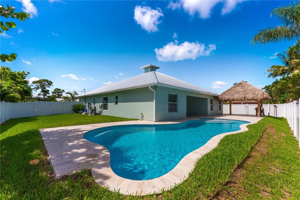 4833 Southeast Pilot Way Stuart, FL 34997 - Photo 1 of 37 a view of a house with swimming pool yard and a patio