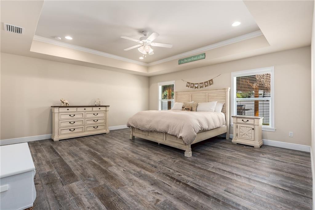 4833 Southeast Pilot Way Stuart, FL 34997 - Photo 14 of 37 a bedroom with a large bed and a chandelier