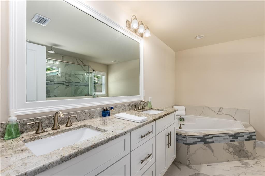 4833 Southeast Pilot Way Stuart, FL 34997 - Photo 15 of 37 a bathroom with a granite countertop sink and a mirror