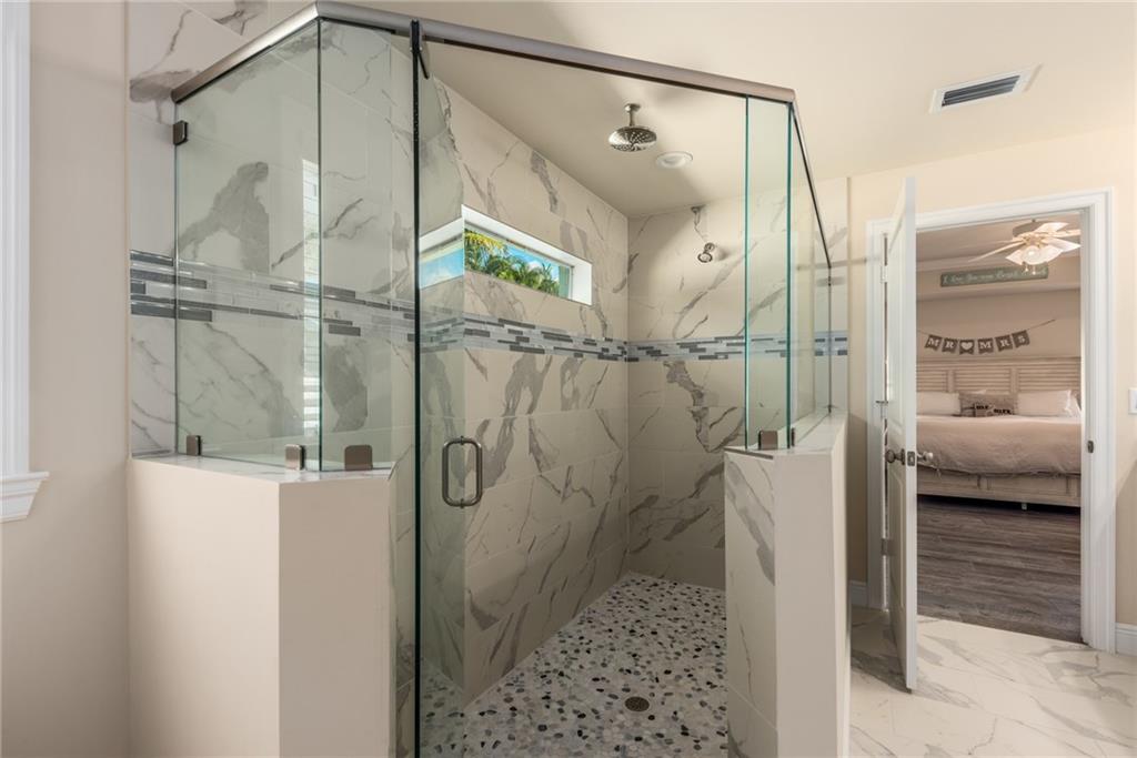 4833 Southeast Pilot Way Stuart, FL 34997 - Photo 16 of 37 a bathroom with a shower and a glass door