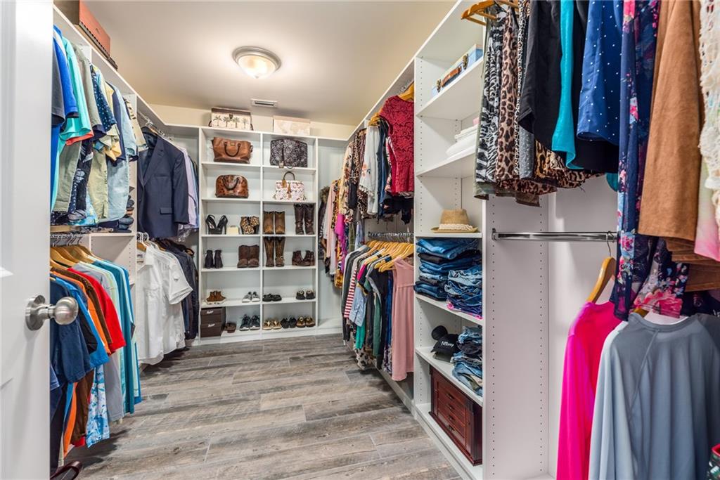 4833 Southeast Pilot Way Stuart, FL 34997 - Photo 17 of 37 a view of walk in closet with clothes and shoes
