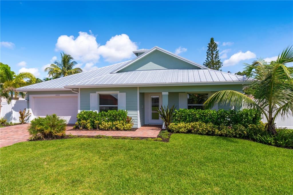 4833 Southeast Pilot Way Stuart, FL 34997 - Photo 2 of 37 a front view of a house with a yard
