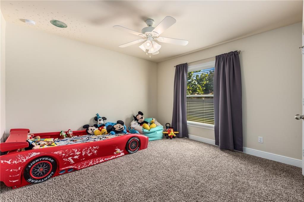 4833 Southeast Pilot Way Stuart, FL 34997 - Photo 26 of 37 a bedroom with a bed and a chandelier