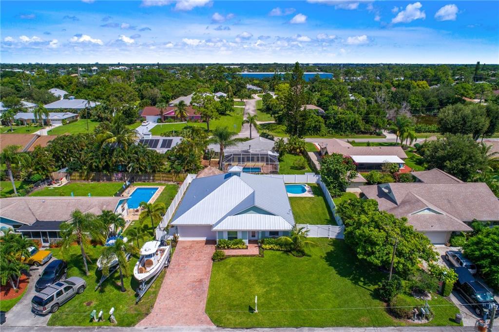 4833 Southeast Pilot Way Stuart, FL 34997 - Photo 32 of 37 an aerial view of a house with a swimming pool outdoor seating and yard