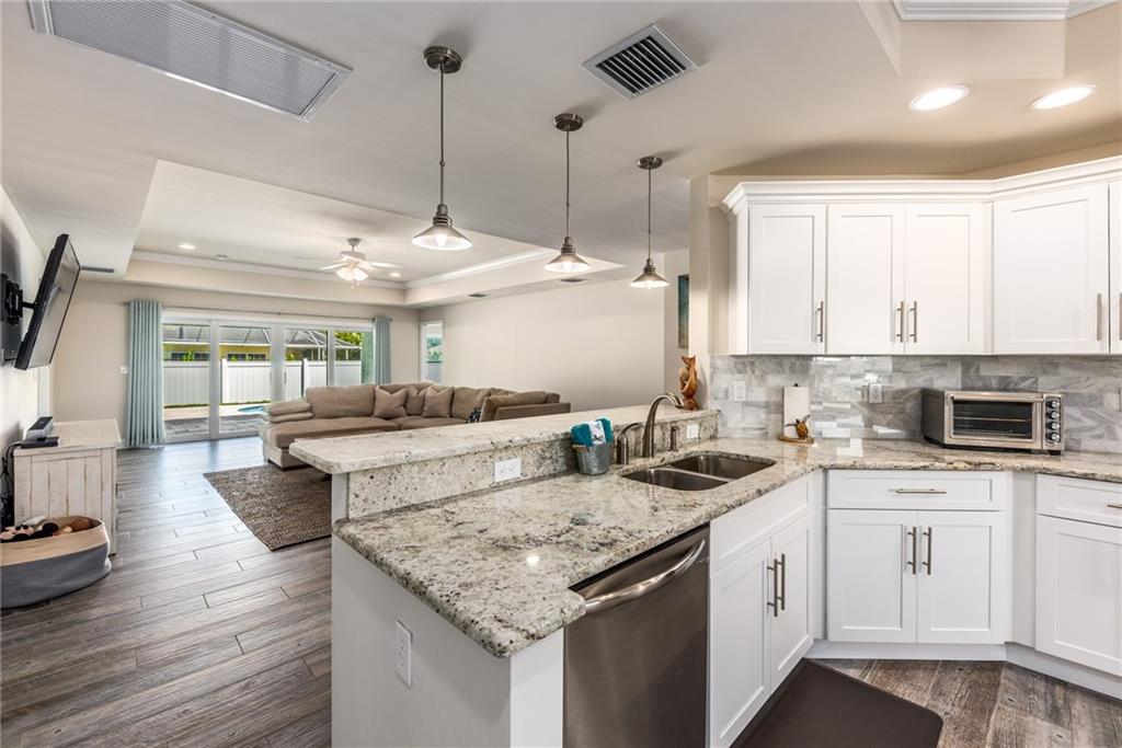 4833 Southeast Pilot Way Stuart, FL 34997 - Photo 6 of 37 a kitchen with a sink stove and cabinets