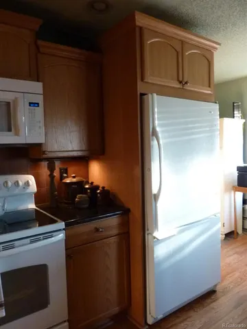 a kitchen with a sink a counter top space and cabinets