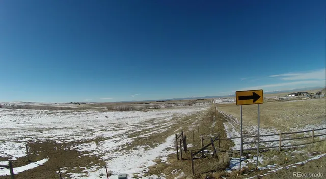 a backyard view with wooden fence