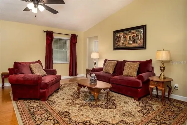 a living room with furniture and a lamp