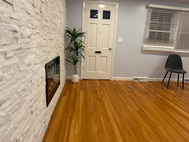 a view of a room with wooden floor and chair