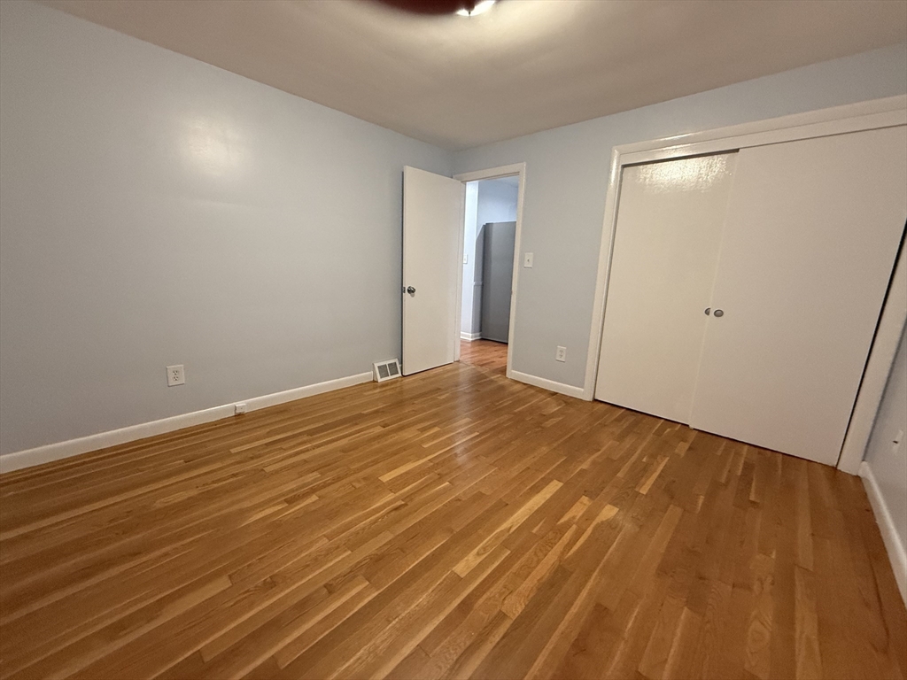 7 Champlain Road, Unit 1 Salem, MA 01970 - Photo 4 of 11 a view of an empty room with wooden floor