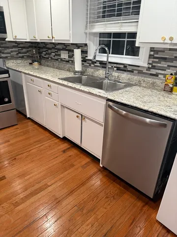 a kitchen with stainless steel appliances granite countertop a sink and a microwave