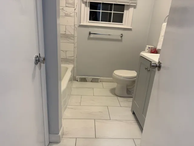 a bathroom with a toilet and a shower