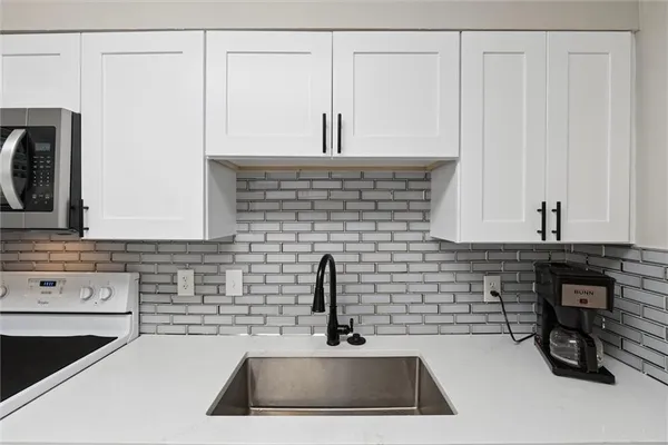 a kitchen with a sink and cabinets