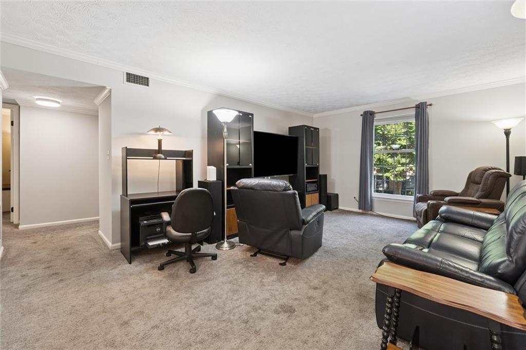 6700 Roswell Road, Unit 31B Atlanta, GA 30328 - Photo 11 of 32 a view of a livingroom with workspace and a window