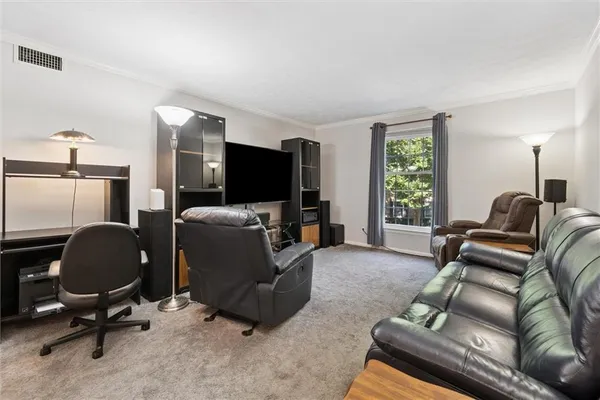 a livingroom with workspace and a couch