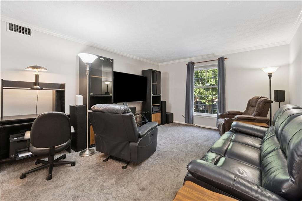 6700 Roswell Road, Unit 31B Atlanta, GA 30328 - Photo 12 of 32 a livingroom with workspace and a couch