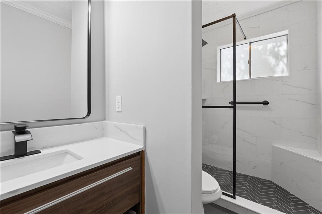 6700 Roswell Road, Unit 31B Atlanta, GA 30328 - Photo 16 of 32 a bathroom with a sink and a shower