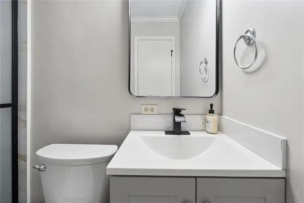 a bathroom with a sink a toilet and a mirror