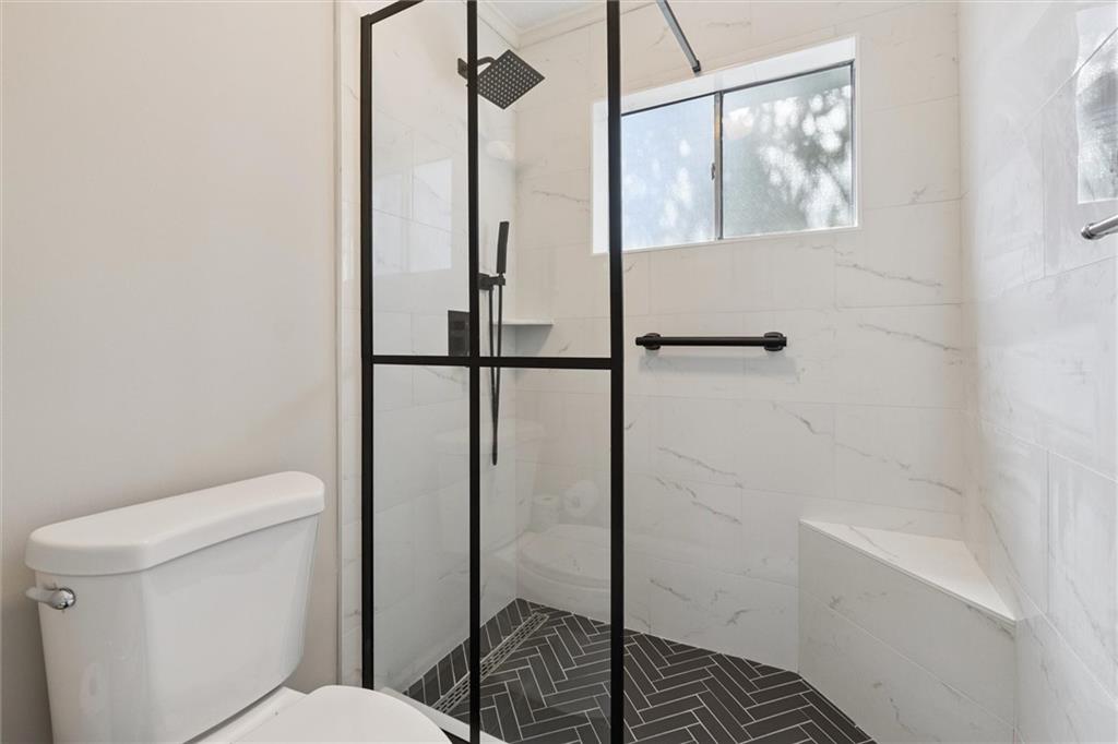 6700 Roswell Road, Unit 31B Atlanta, GA 30328 - Photo 18 of 32 a bathroom with a toilet and a shower