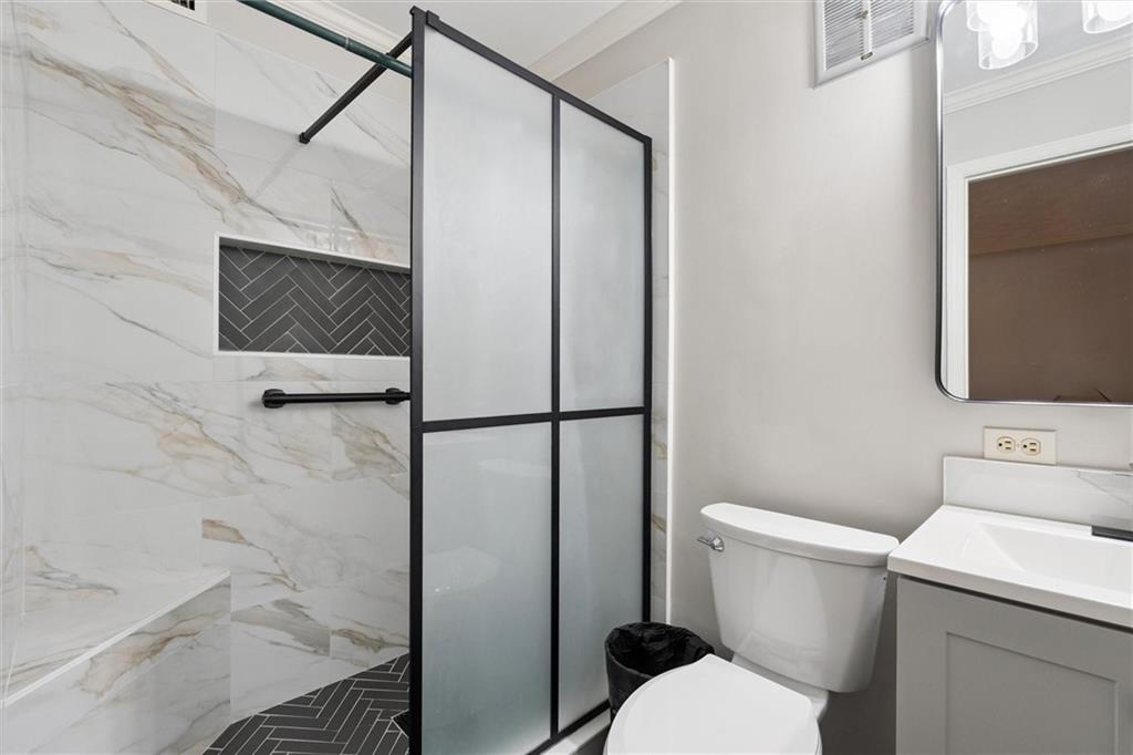 6700 Roswell Road, Unit 31B Atlanta, GA 30328 - Photo 19 of 32 a bathroom with a toilet and a shower