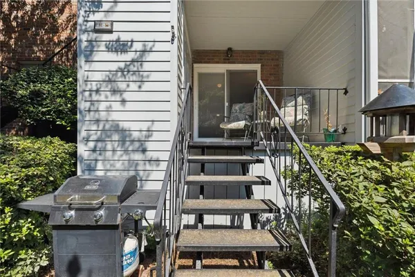 a view of balcony with wooden floor and outdoor seating