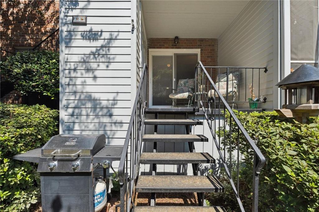 6700 Roswell Road, Unit 31B Atlanta, GA 30328 - Photo 23 of 32 a view of balcony with wooden floor and outdoor seating