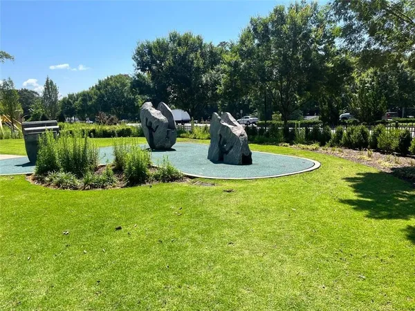 a view of a garden with plants and a slide