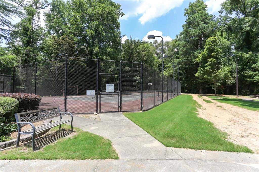 6700 Roswell Road, Unit 31B Atlanta, GA 30328 - Photo 32 of 32 a swimming pool with some trees in the background