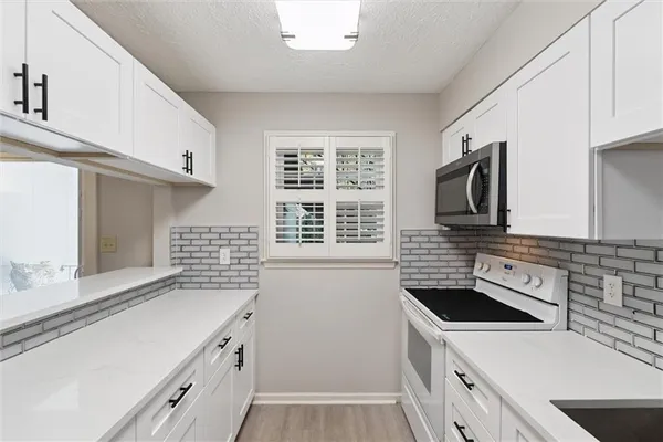 a kitchen with a stove and a sink