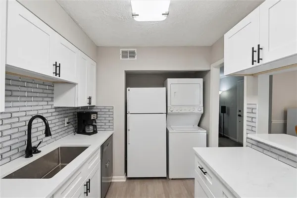 a kitchen with a refrigerator and a sink