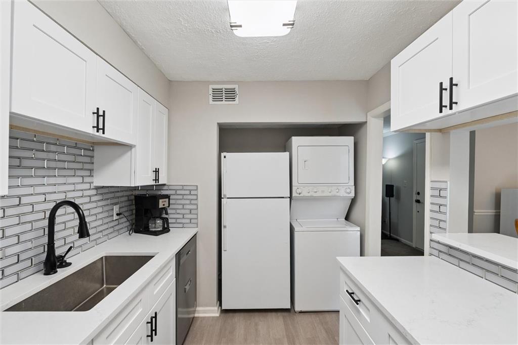 6700 Roswell Road, Unit 31B Atlanta, GA 30328 - Photo 8 of 32 a kitchen with a refrigerator and a sink