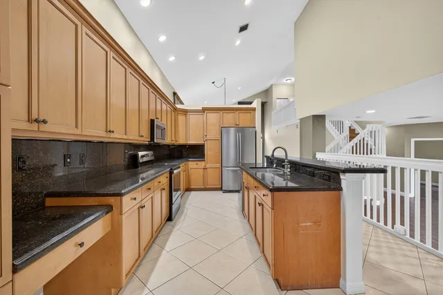 a kitchen with stainless steel appliances granite countertop a stove and a sink