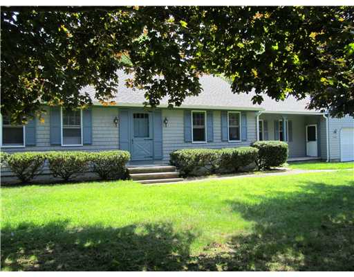 Exterior Front. Privaately set on 1.45 acres with porch and attached garage