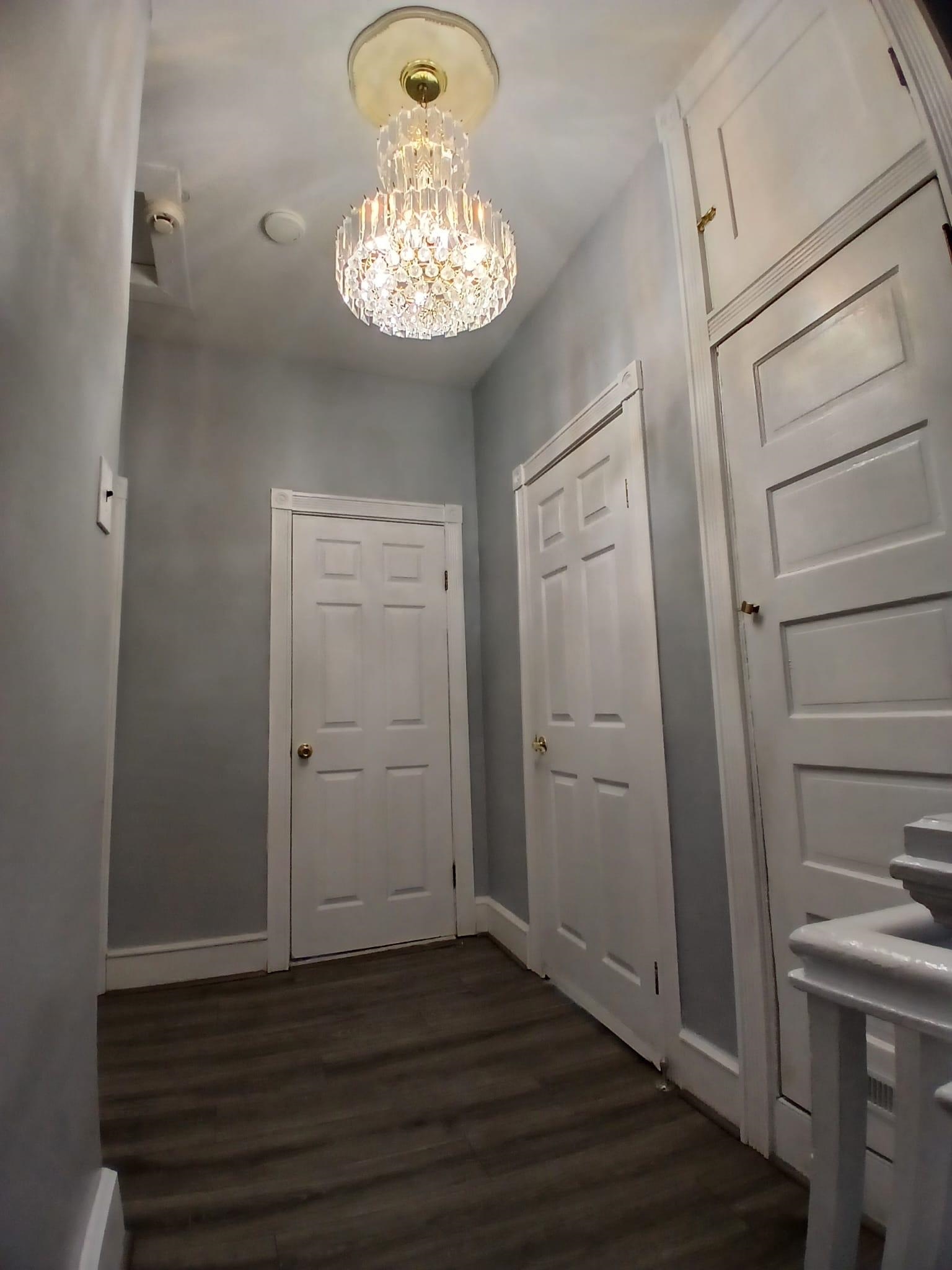 1212 89th Street North Bergen, NJ 07047 - Photo 2 of 41 a view of a hallway with wooden floor and a kitchen
