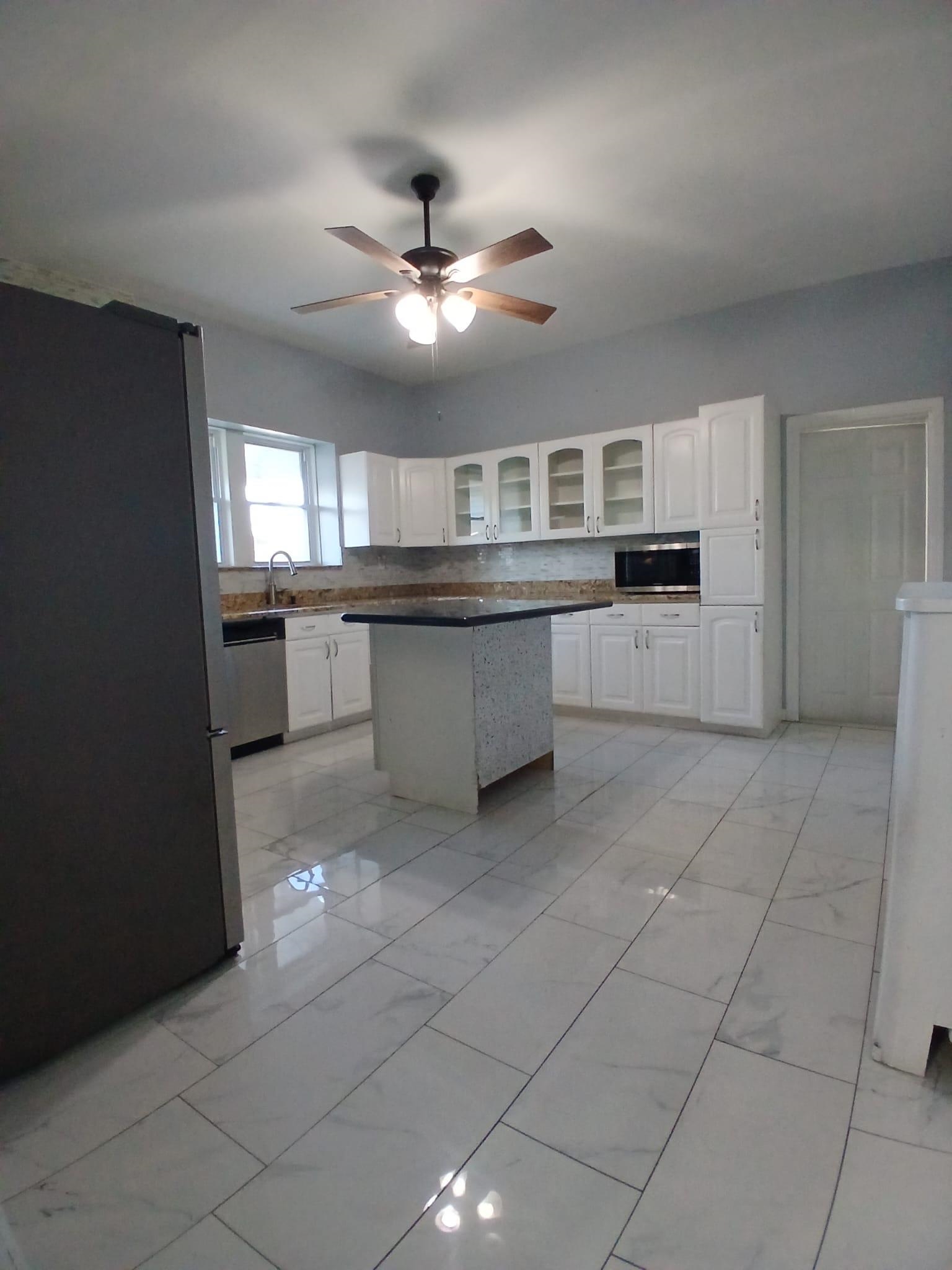 1212 89th Street North Bergen, NJ 07047 - Photo 31 of 41 a large kitchen with cabinets and stainless steel appliances