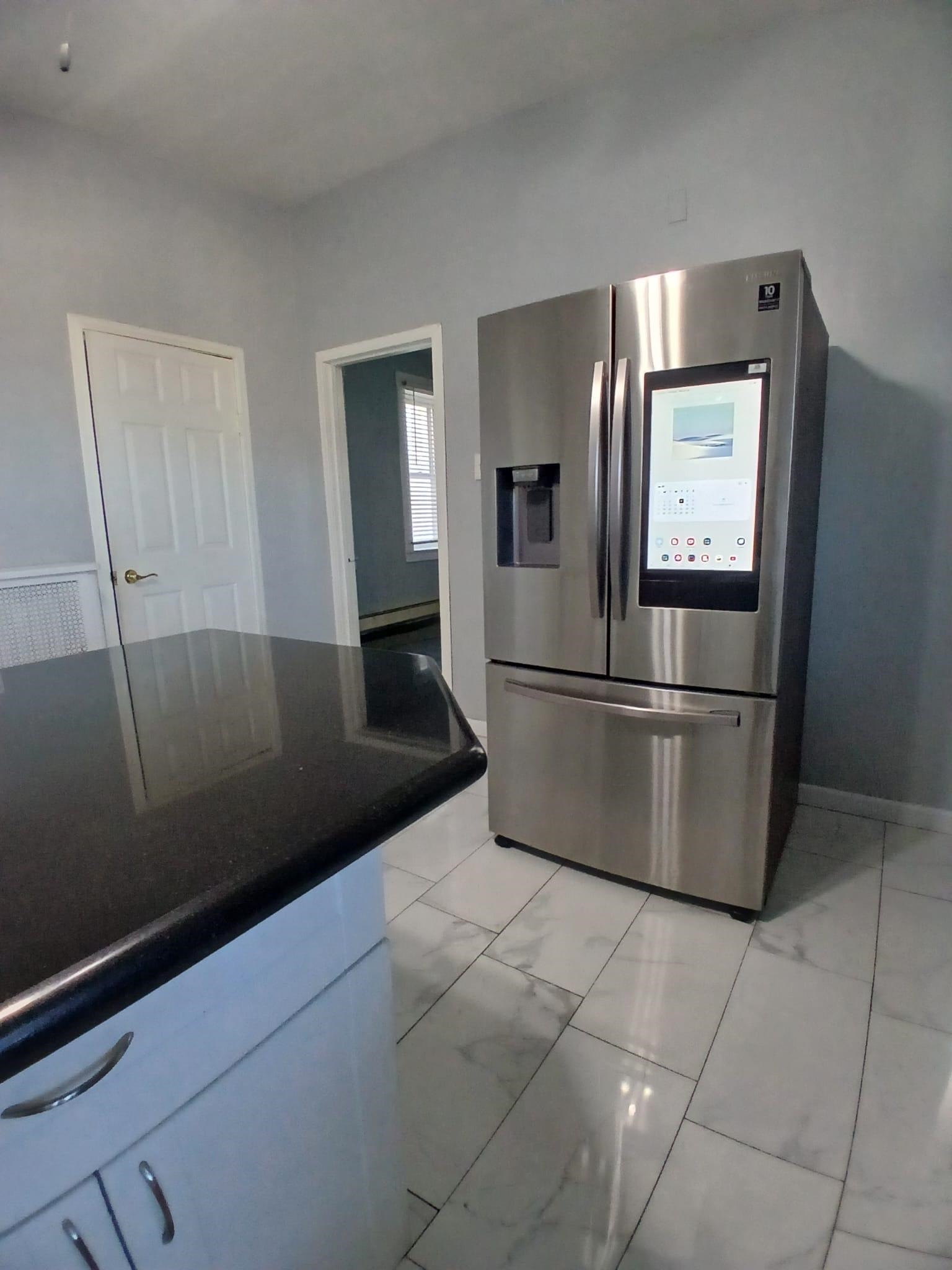1212 89th Street North Bergen, NJ 07047 - Photo 32 of 41 a kitchen with granite countertop a refrigerator and a sink