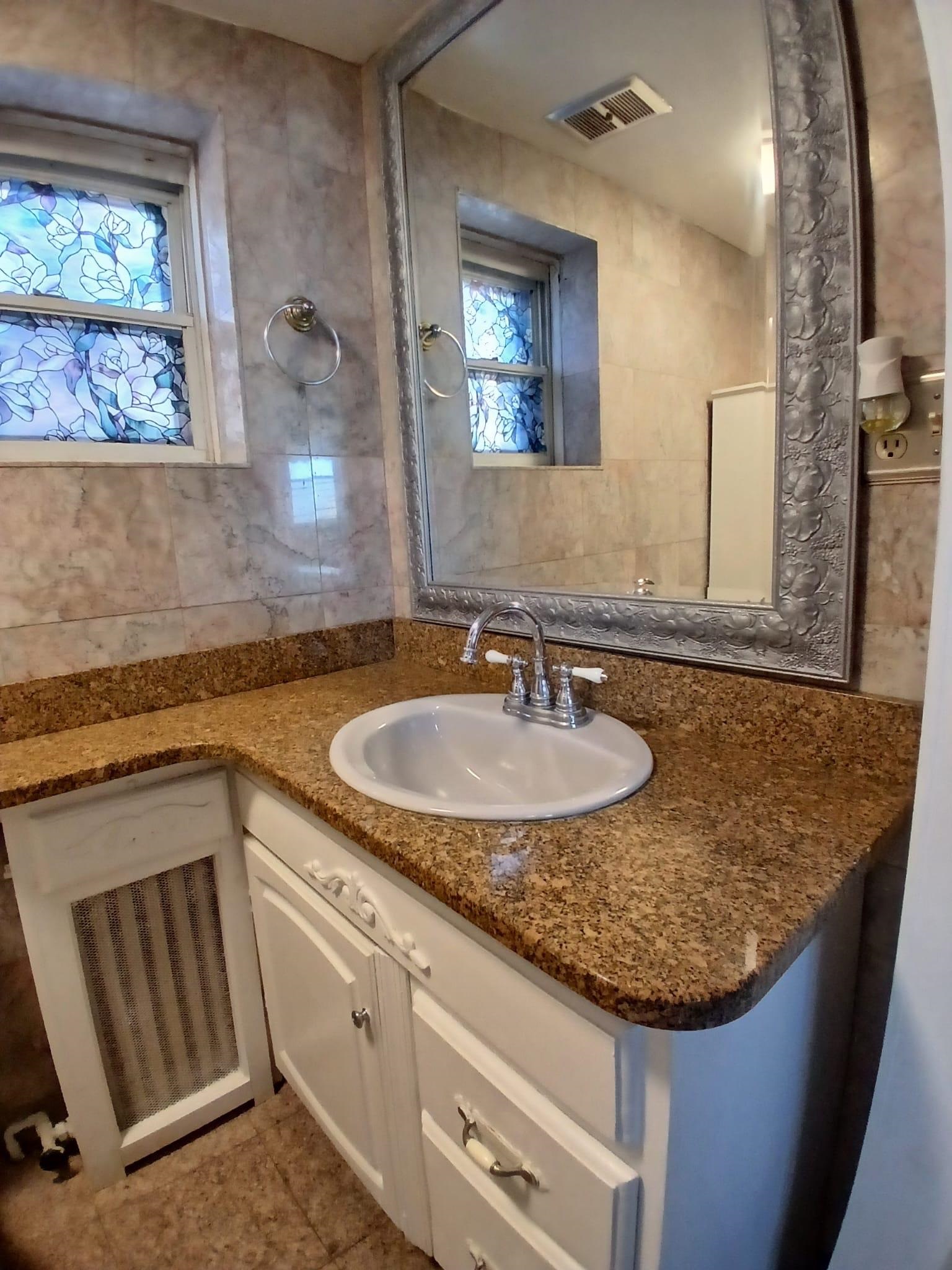 1212 89th Street North Bergen, NJ 07047 - Photo 34 of 41 a bathroom with a granite countertop sink and a mirror