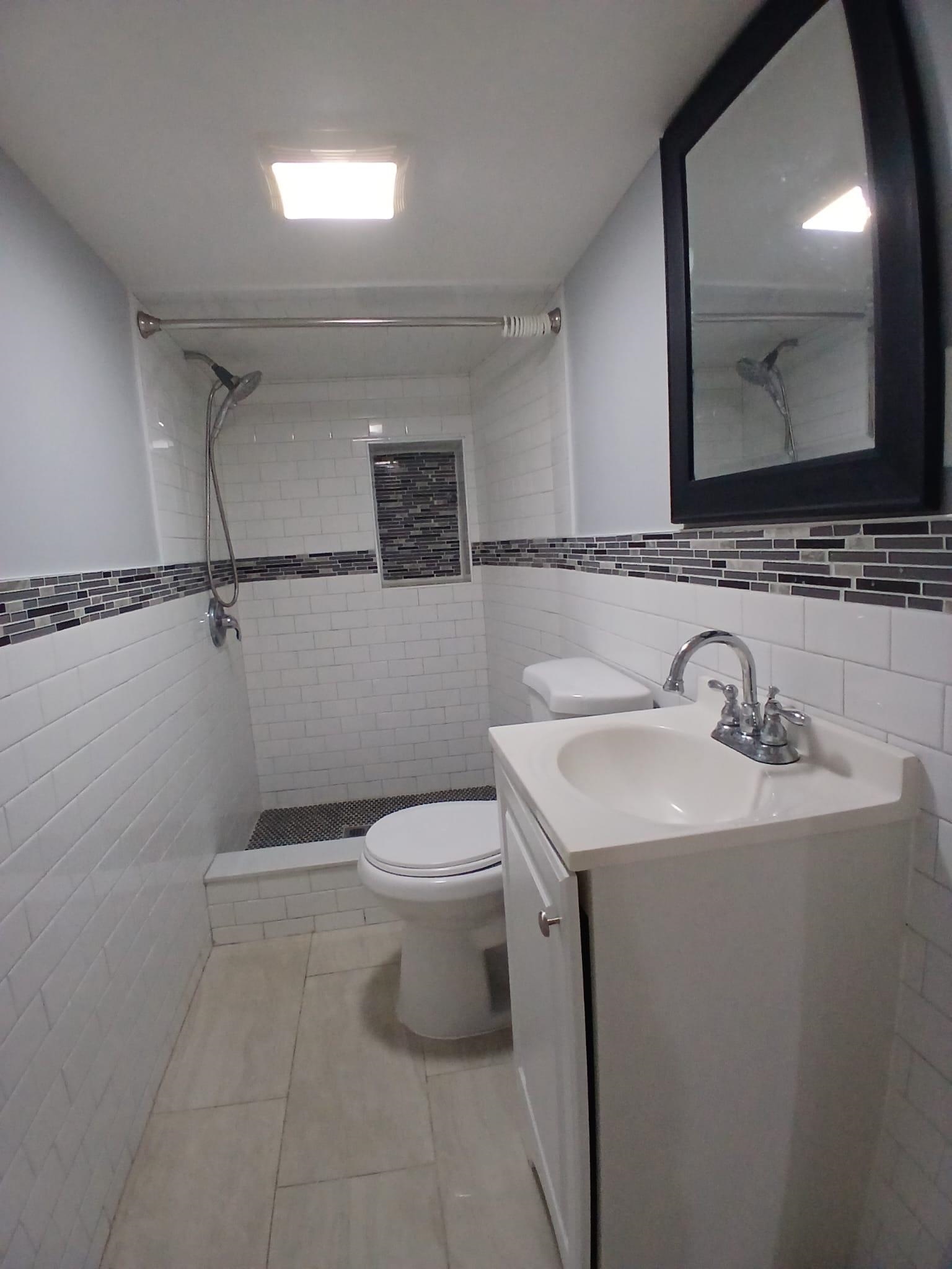 1212 89th Street North Bergen, NJ 07047 - Photo 35 of 41 a bathroom with a toilet sink and mirror