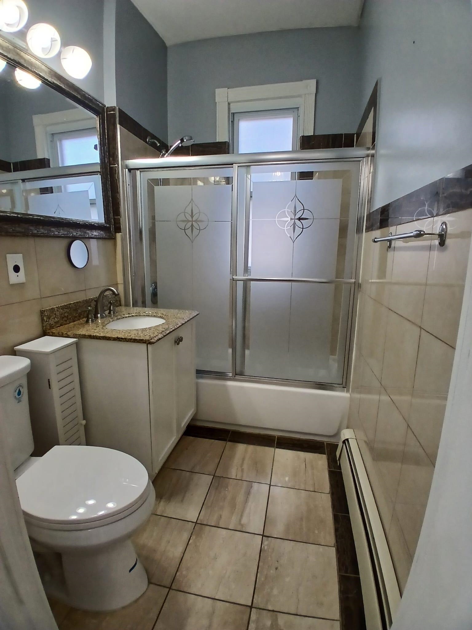 1212 89th Street North Bergen, NJ 07047 - Photo 36 of 41 a bathroom with a sink a toilet and a shower