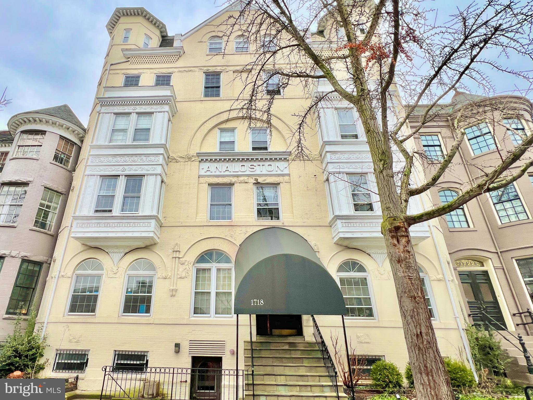 a front view of a residential apartment building with a yard