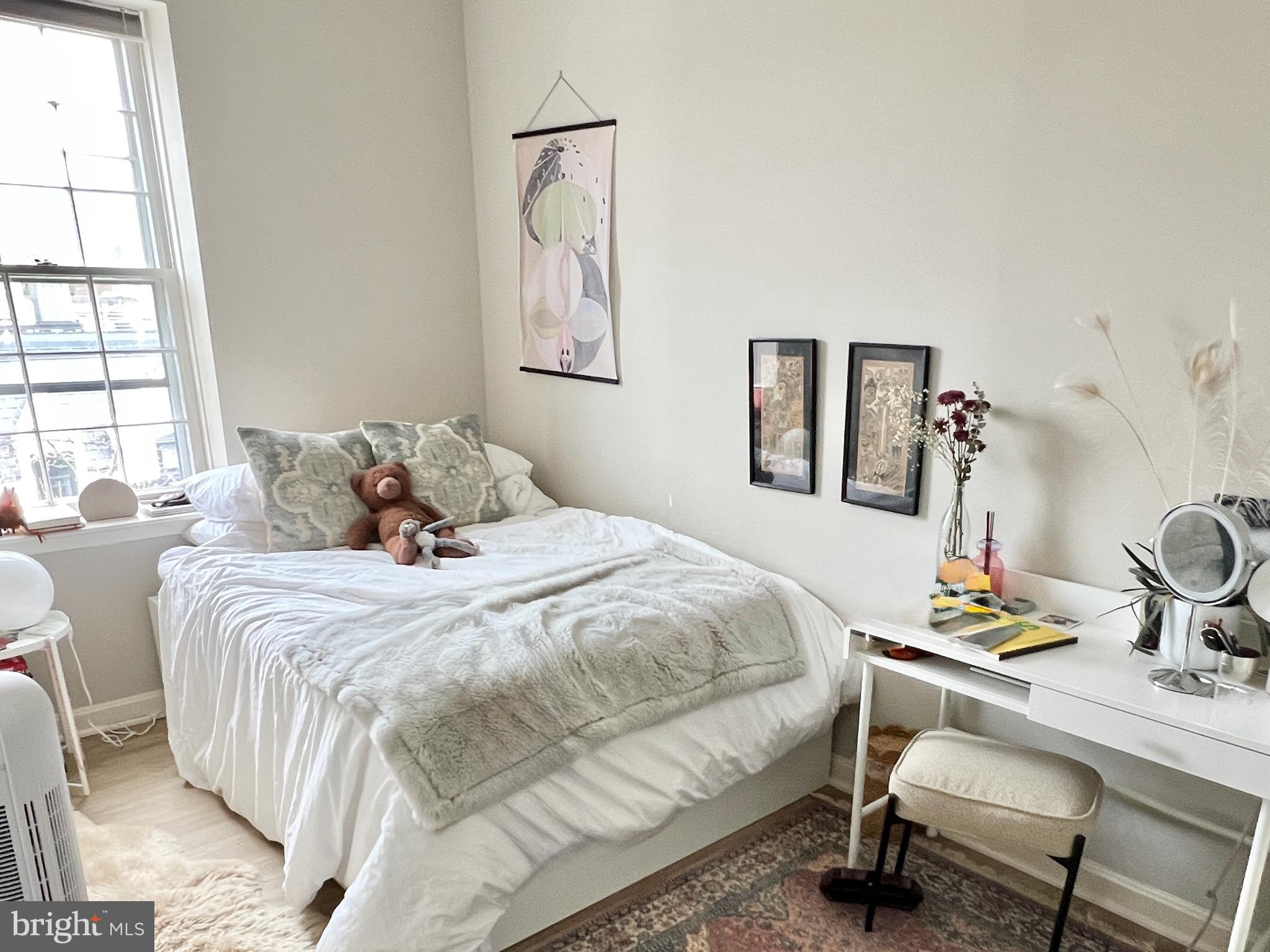 1718 Corcoran Street Northwest, Unit 45 Washington, DC 20009 - Photo 7 of 13 a bedroom with a bed and a table in it
