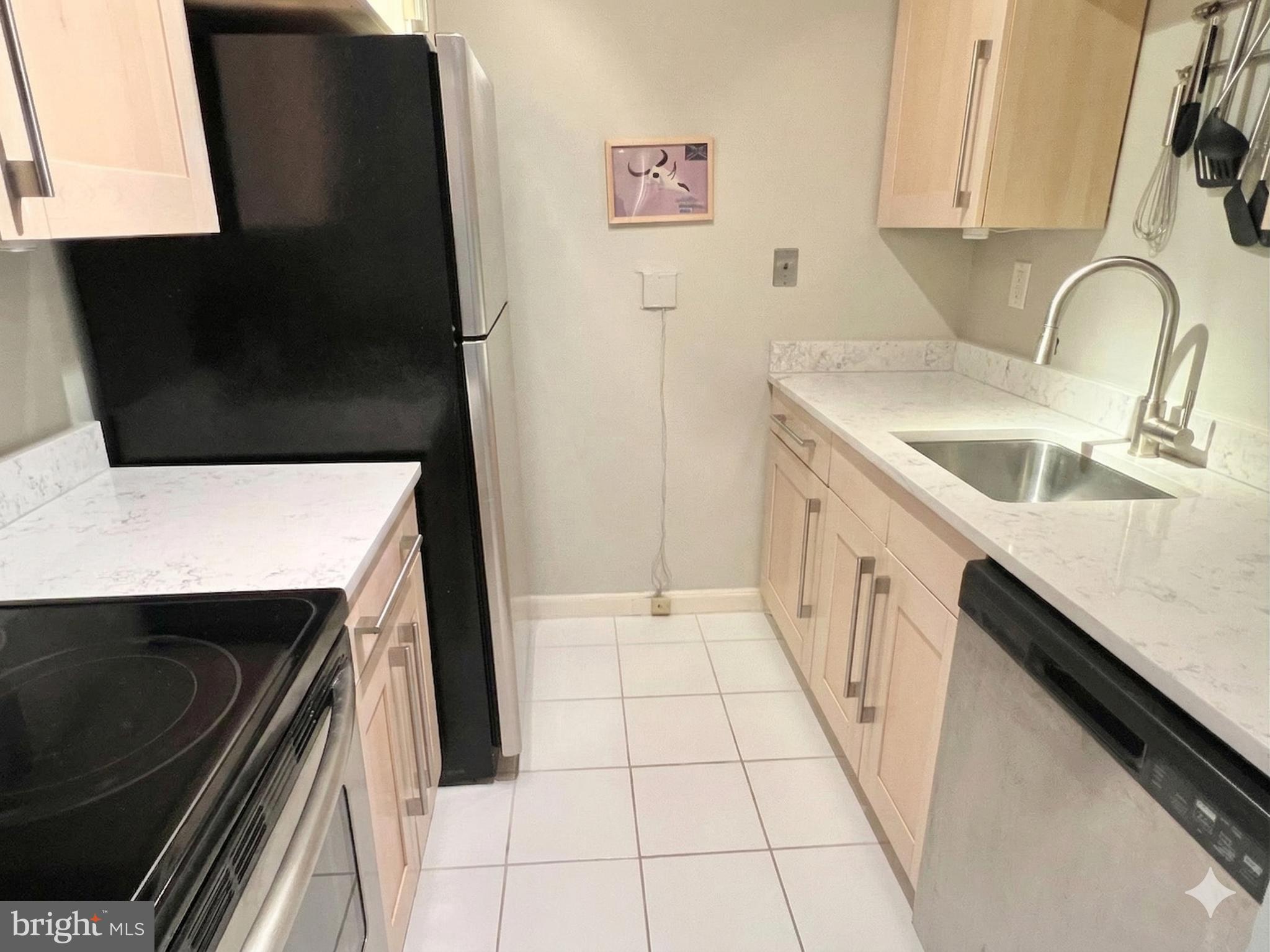 1718 Corcoran Street Northwest, Unit 45 Washington, DC 20009 - Photo 8 of 13 a kitchen with a sink and a stove top oven