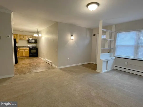 a view of a kitchen with a sink and a refrigerator