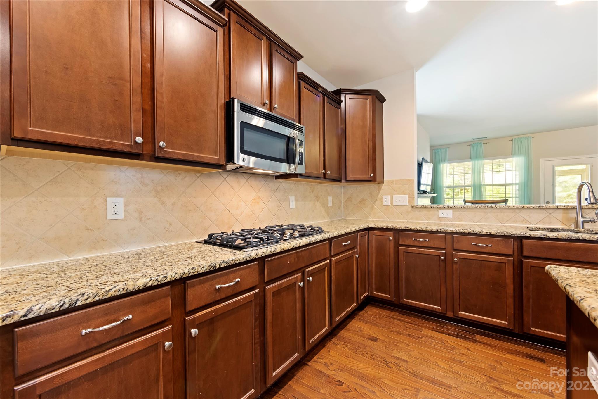 4087 Perth Road Indian Land, SC 29707 - Photo 13 of 46 a kitchen with stainless steel appliances granite countertop a sink stove and microwave