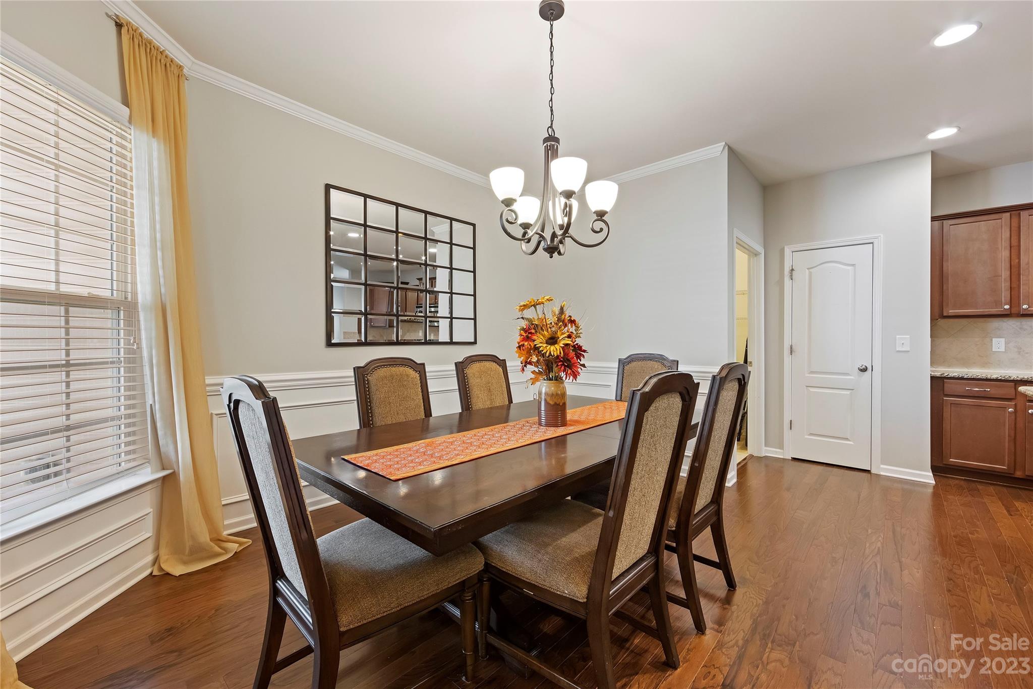 4087 Perth Road Indian Land, SC 29707 - Photo 8 of 46 a view of a dining room with furniture a chandelier and wooden floor