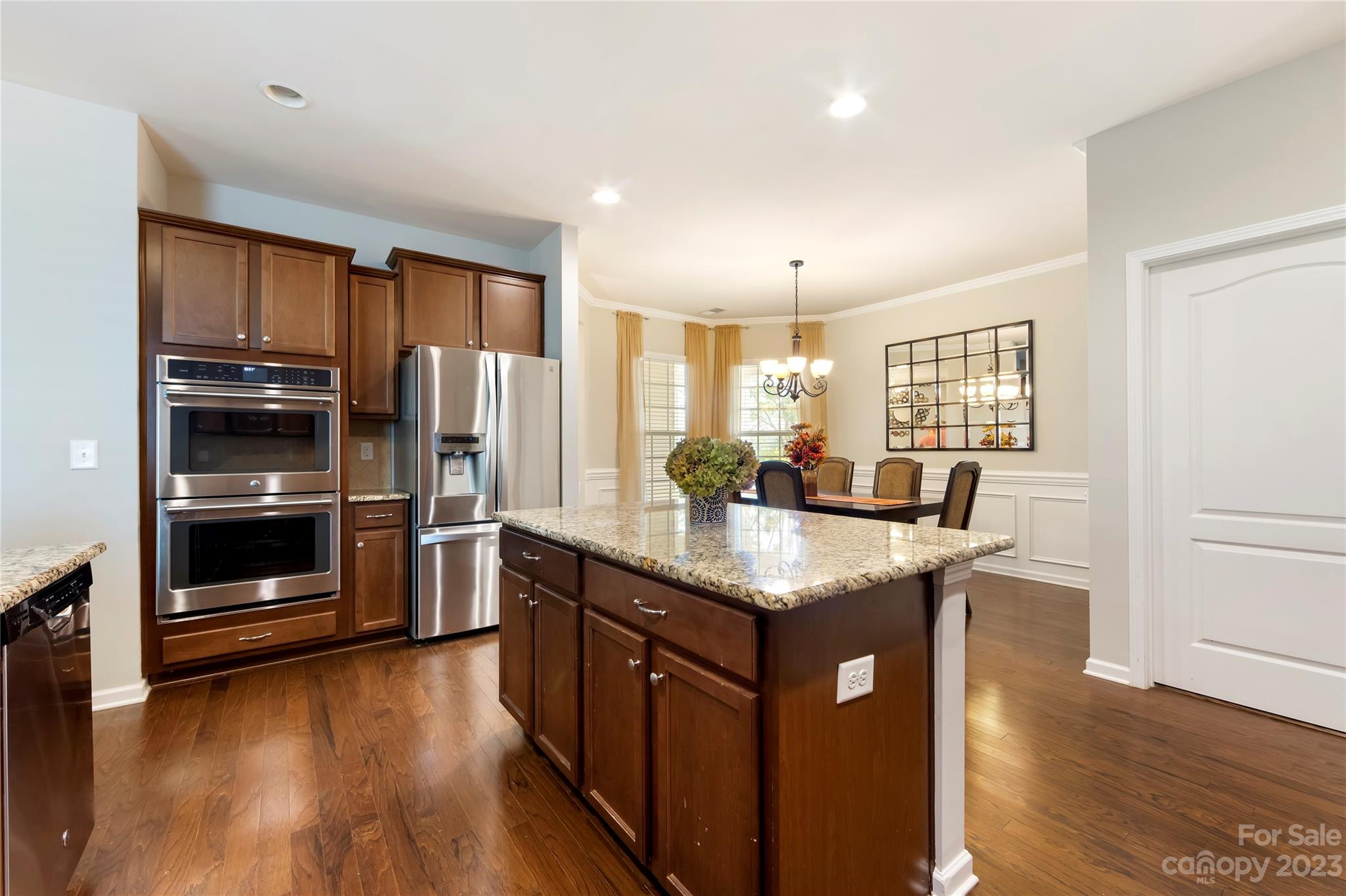 4087 Perth Road Indian Land, SC 29707 - Photo 10 of 46 a kitchen with stainless steel appliances granite countertop a refrigerator a stove and a wooden floors