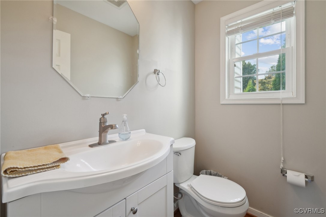 7101 Conifer Road Richmond, VA 23237 - Photo 26 of 50 a bathroom with a sink a toilet and a window