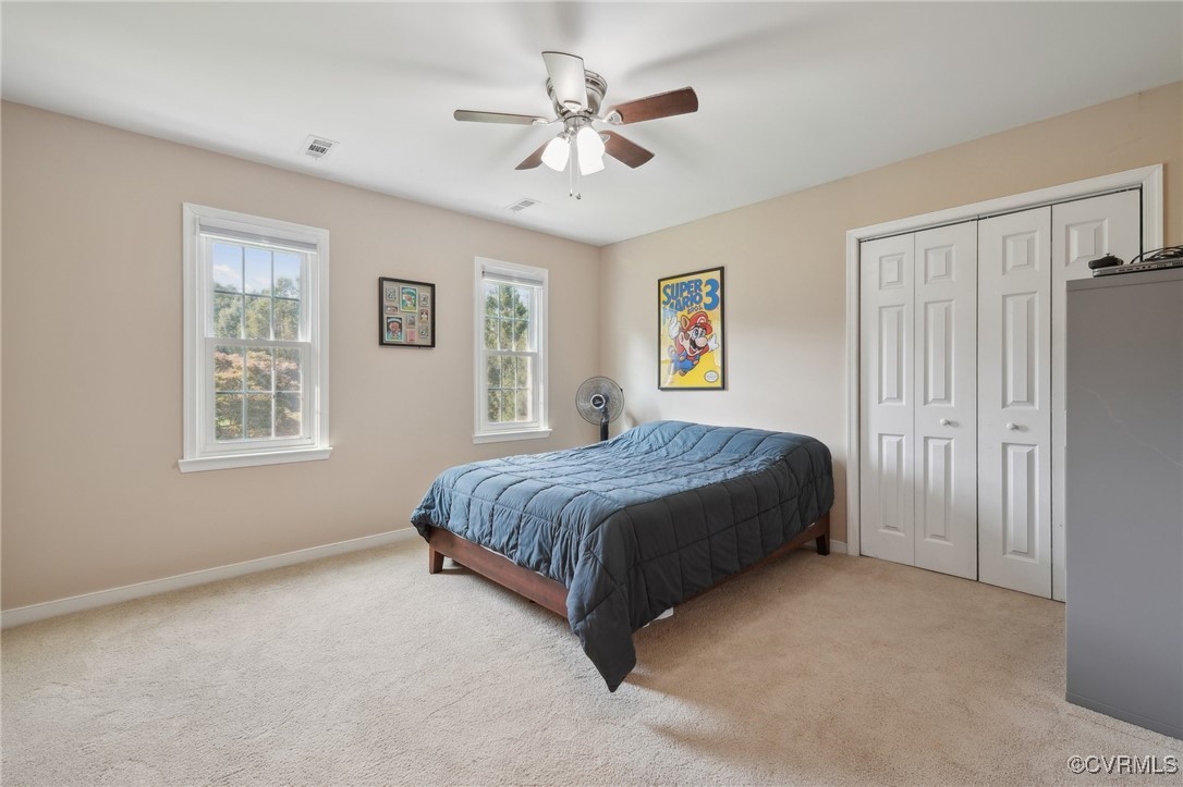 7101 Conifer Road Richmond, VA 23237 - Photo 33 of 50 a spacious bedroom with a large bed chandelier and a window